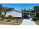 Cozy home featuring an awning-covered entrance and well-maintained landscaping at 861 Seabrooke Dr, Englewood, FL 34223