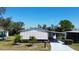 Well maintained single Gathering home with covered carport, mature landscaping, and charming curb appeal at 861 Seabrooke Dr, Englewood, FL 34223