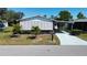 Well maintained single Gathering home with covered carport, mature landscaping, and charming curb appeal at 861 Seabrooke Dr, Englewood, FL 34223