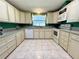 Efficient kitchen with ample counter space, white appliances, and a bright, airy feel at 861 Seabrooke Dr, Englewood, FL 34223