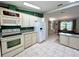Well-equipped kitchen featuring white appliances, ample storage, and an adjacent dining area at 861 Seabrooke Dr, Englewood, FL 34223