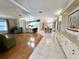 Open-concept living area flows into kitchen and dining with hardwood floors and bright, neutral decor at 861 Seabrooke Dr, Englewood, FL 34223