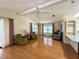 Comfortable living room with hardwood floors, ceiling fan, and a view of an adjacent kitchen at 861 Seabrooke Dr, Englewood, FL 34223