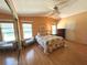Bright main bedroom with hardwood floors, sitting area and large window at 861 Seabrooke Dr, Englewood, FL 34223