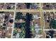 Aerial view of a home with a canal front, situated in a residential neighborhood at 1022 Waterside St, Port Charlotte, FL 33952