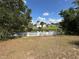 Backyard view featuring a white picket fence and a tranquil canal, enhancing privacy at 1022 Waterside St, Port Charlotte, FL 33952