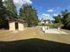 Spacious backyard with a shed, a grill and a white picket fence near the lake at 1022 Waterside St, Port Charlotte, FL 33952