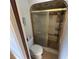 Cozy bathroom showcasing a tiled shower with a golden frame, alongside a standard toilet at 1022 Waterside St, Port Charlotte, FL 33952