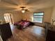 Relaxing bedroom with wood-look flooring, a ceiling fan, and a large window at 1022 Waterside St, Port Charlotte, FL 33952