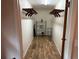 Walk-in closet featuring wood-look flooring, shelving, and ample storage space at 1022 Waterside St, Port Charlotte, FL 33952