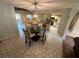 Spacious dining area with a glass table, stylish chairs, and unique flooring at 1022 Waterside St, Port Charlotte, FL 33952