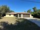 Charming single-story home featuring a well-maintained lawn and an attached two-car garage at 1022 Waterside St, Port Charlotte, FL 33952