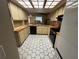 Charming kitchen featuring tile countertops, modern appliances, and adjacent dining area at 1022 Waterside St, Port Charlotte, FL 33952