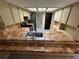 Bright kitchen featuring tile countertops and backsplash, along with ample cabinet space at 1022 Waterside St, Port Charlotte, FL 33952