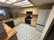 Updated kitchen with modern appliances, tile countertops, and stylish hexagonal flooring at 1022 Waterside St, Port Charlotte, FL 33952