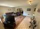 Open living room with wood and tile flooring, featuring a comfortable seating area and ample natural light at 1022 Waterside St, Port Charlotte, FL 33952