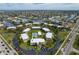 Aerial view of condos with central pool, circular drive, ample parking, and waterway views at 1080 Bal Harbor Blvd # 10C, Punta Gorda, FL 33950