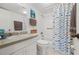 Cozy bathroom featuring a fish-themed shower curtain and ample countertop space at 1080 Bal Harbor Blvd # 10C, Punta Gorda, FL 33950