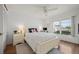Bright bedroom with wood floors, a large window, and white furnishings at 1080 Bal Harbor Blvd # 10C, Punta Gorda, FL 33950