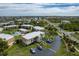 Wide aerial shot displays the community, neighboring houses, street and surrounding lush, green spaces at 1080 Bal Harbor Blvd # 10C, Punta Gorda, FL 33950