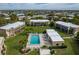 Overhead showcases community pool, lounge chairs and tables for residents with surrounding lush landscaping at 1080 Bal Harbor Blvd # 10C, Punta Gorda, FL 33950
