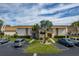 Attractive exterior of a two-story condo building with well-maintained landscaping and ample parking at 1080 Bal Harbor Blvd # 10C, Punta Gorda, FL 33950
