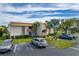 Condominium complex featuring lush tropical landscaping and convenient parking at 1080 Bal Harbor Blvd # 10C, Punta Gorda, FL 33950