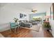 Sunlit living room with modern furnishings, opening to a balcony with outdoor views at 1080 Bal Harbor Blvd # 10C, Punta Gorda, FL 33950
