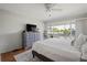 Bright main bedroom features a large window, ceiling fan and well-appointed furniture at 1080 Bal Harbor Blvd # 10C, Punta Gorda, FL 33950