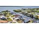 Waterfront homes with private docks line tranquil canals in this scenic aerial view near a beautiful bay at 12387 Minot Ave, Port Charlotte, FL 33981