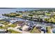 Waterfront homes with private docks line tranquil canals in this scenic aerial view near a beautiful bay at 12387 Minot Ave, Port Charlotte, FL 33981