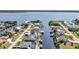 Waterfront homes with private docks line tranquil canals in this scenic aerial view near a beautiful bay at 12387 Minot Ave, Port Charlotte, FL 33981