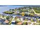 Aerial view of a waterfront home showcasing its canal-front location and neighborhood at 12387 Minot Ave, Port Charlotte, FL 33981
