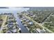 Scenic aerial view showcases waterfront homes along a canal with boats docked, surrounded by lush greenery at 12387 Minot Ave, Port Charlotte, FL 33981
