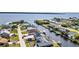 Waterfront homes with private docks line tranquil canals in this scenic aerial view near a beautiful bay at 12387 Minot Ave, Port Charlotte, FL 33981