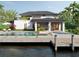 Beautiful backyard featuring a swimming pool, dock, and outdoor seating area perfect for relaxation at 12387 Minot Ave, Port Charlotte, FL 33981