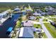 Waterfront property boasts a private dock and easy access to the canals, plus beautiful landscaping at 12676 Bacchus Rd, Port Charlotte, FL 33981