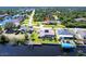 Aerial view of a waterfront home featuring a private dock and solar panels, with easy canal access at 12676 Bacchus Rd, Port Charlotte, FL 33981