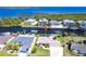 Aerial view of a waterfront home with a private dock, solar panels, and access to beautiful blue waters at 12676 Bacchus Rd, Port Charlotte, FL 33981