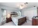Bright bedroom showcases a plush bed, ceiling fan, and a view of the outdoors at 12676 Bacchus Rd, Port Charlotte, FL 33981