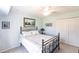 Inviting bedroom features a comfortable bed, a ceiling fan, and traditional decor at 12676 Bacchus Rd, Port Charlotte, FL 33981