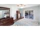This bedroom has dark wood furniture and a sliding glass door that opens up to the pool at 12676 Bacchus Rd, Port Charlotte, FL 33981