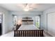 Charming bedroom with coordinated linens, side tables, and a well-lit ceiling fan at 12676 Bacchus Rd, Port Charlotte, FL 33981