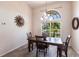 Dining room with a view, featuring stylish chandelier and window at 12676 Bacchus Rd, Port Charlotte, FL 33981