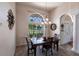 Comfortable dining area with lots of natural light, chandelier, and backyard views at 12676 Bacchus Rd, Port Charlotte, FL 33981
