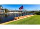 Waterfront property featuring a private wooden dock with a boat lift, perfect for boating enthusiasts at 12676 Bacchus Rd, Port Charlotte, FL 33981
