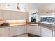 Bright kitchen features white cabinetry, tile backsplash, and modern appliances at 12676 Bacchus Rd, Port Charlotte, FL 33981