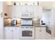 Well-equipped kitchen with white cabinets, modern appliances, and stylish backsplash at 12676 Bacchus Rd, Port Charlotte, FL 33981