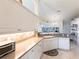 Well-lit kitchen featuring neutral countertops, cabinets, and appliances with a backyard view at 12676 Bacchus Rd, Port Charlotte, FL 33981