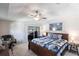 Inviting main bedroom with sliding doors, ceiling fan, and a comfortable bed at 12676 Bacchus Rd, Port Charlotte, FL 33981